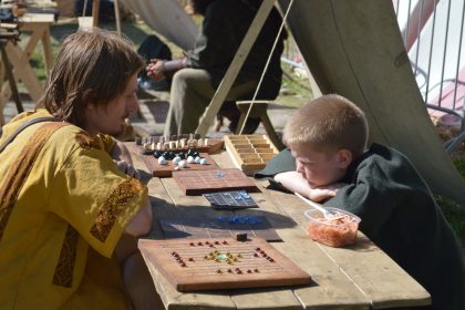 Two opponents playing Viking chess or hnefatafl.