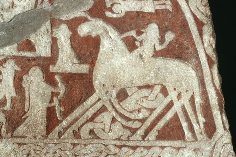 Detail of the Tjängvide picture stone from Gotland: a rider on an eight-legged horse, usually read as Odin on Sleipnir, greeted by a woman holding a drinking horn