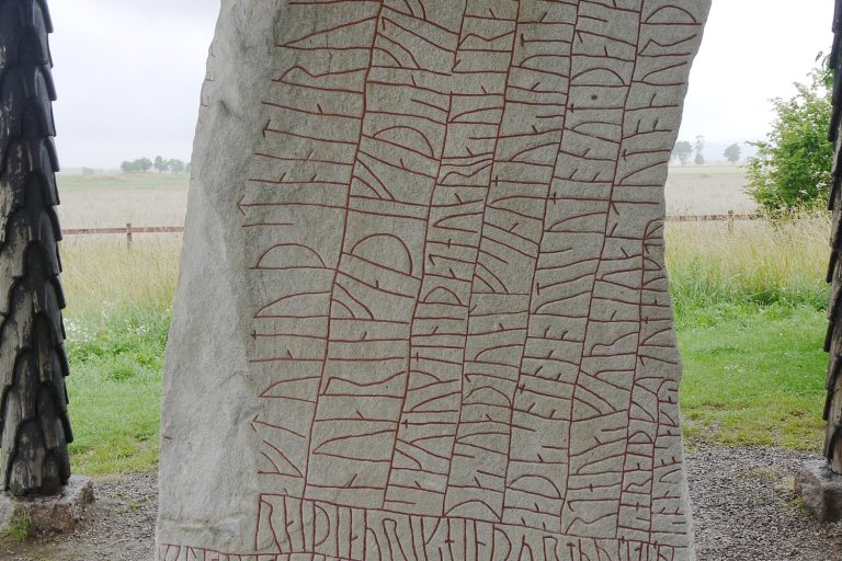 The Rök runestone in Östergötland, Sweden, its face covered in red-painted runes, the longest runic inscription of the Viking Age