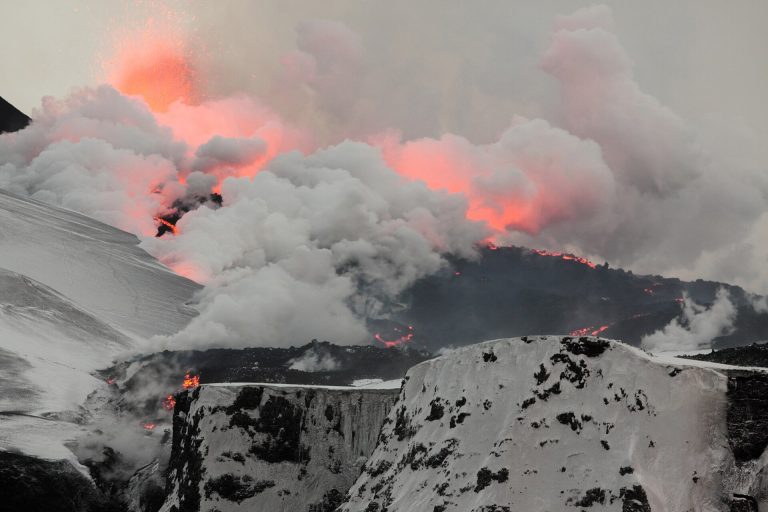 Lava and steam bursting from a snow-covered ridge during the 2010 Fimmvörðuháls eruption in Iceland