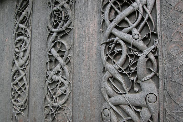 Interlaced serpents and a four-legged beast carved in wood on the north portal of Urnes stave church, Norway